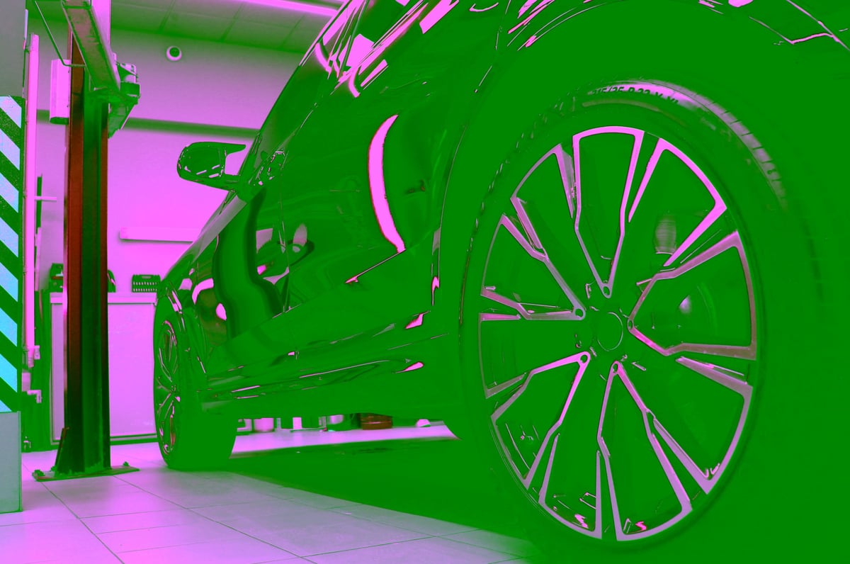 Gleaming black SUV in a detailing studio under warm golden-hour light
