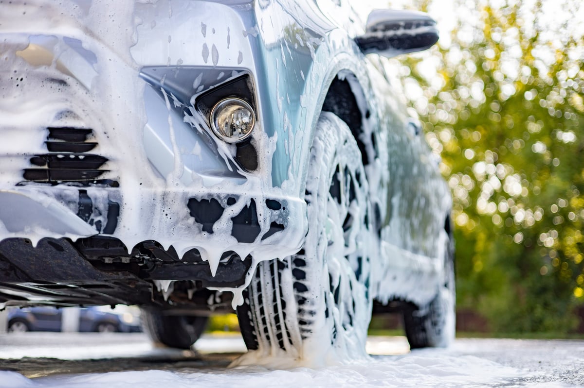 Thick snow foam covering a car during a professional detail wash
