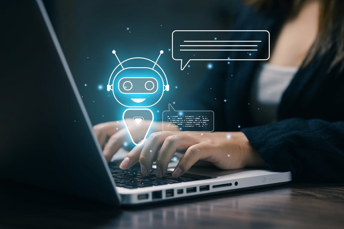 Businesswoman using laptop with virtual chatbot interface illustrating AI customer service and automated support